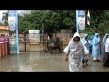 People protect themselves from rain using plastic bags and rain coats, Rishikesh