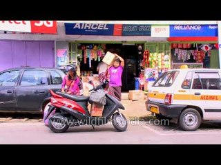 Indian woman loads goods on her TVS scooty in Aizawl, Mizoram