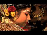 Shy bride at Bengali wedding in India : pouring water onto palm of hand