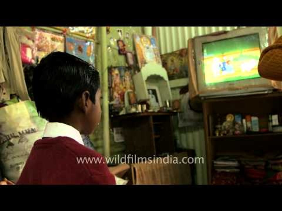 Mother feeds rice to her son before going school, Assam