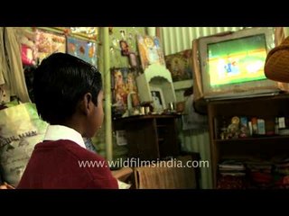 Mother feeds rice to her son before going school, Assam
