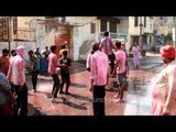 People smear in colors celebrate Holi in Vrindavan