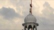 Sikh man wraps Nishan Sahib at Sri Keshgarh Sahib Gurudwara, Punjab