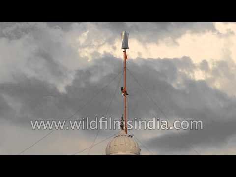 Man changes Nishan Sahib at Sri Keshgarh Sahib Gurudwara - Punjab