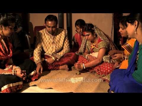 Bride and groom performs a ritual at Bengali wedding