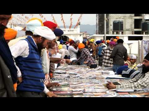 Man sells religious books at Gurudwara Takht Sri Keshgarh Sahib, India