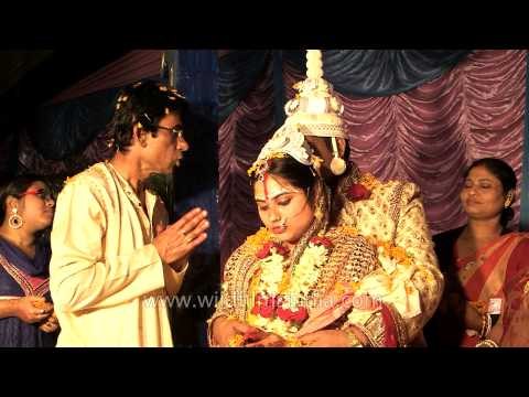 Groom and bride performs Bengali wedding rituals