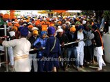Devotees await their turn to pay obeisance to Sikh Guru at Kesgarh Sahib Gurudwara, Punjab