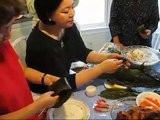 Making Joong (sticky rice, beans and salted pork wrapped in bamboo leaves)