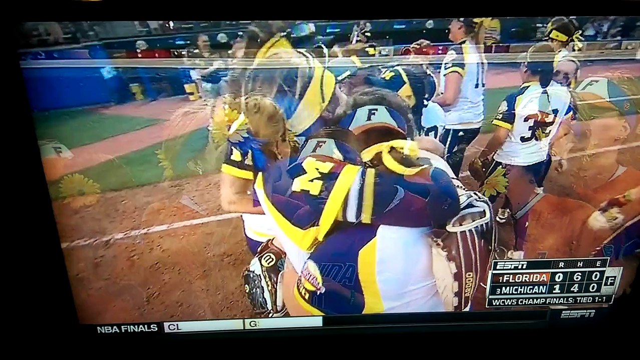 Michigan Softball girls celebrate and perhaps kiss