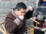 Blowing sugar into a shape of a mouse in Sichuan Chengdu