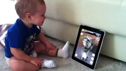 baby talks with cat