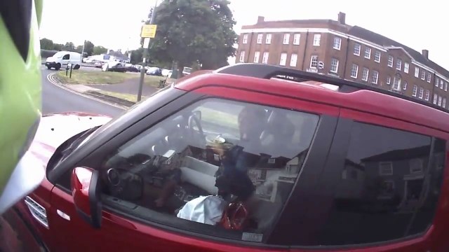 Bicyclist disapproves driver eating cereals while driving