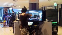 Dedicated asian gamer-dude at arcade