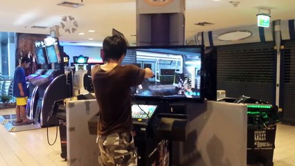 Dedicated asian gamer-dude at arcade