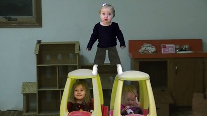 One year old girl does the splits on cars.