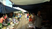 Train passes through Thai market