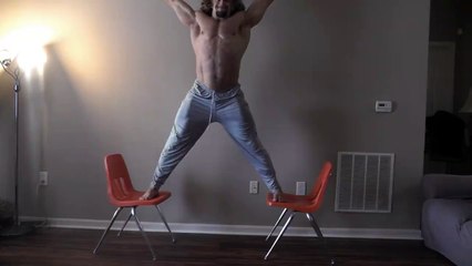 Weightlifter holds up 100lbs while doing chair splits