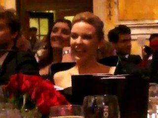 Kylie Minogue watches as her "Kylie Package" is auctioned off at AMFAR event