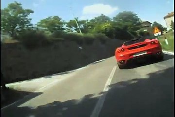 Ducati 1198 high speed chasing a Ferrari in Italy