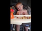 Baby falls asleep while eating in his highchair