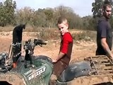 kid on grizzly 700 mudding