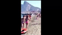 Drug dealers unloading drug on spanish beach in front of people