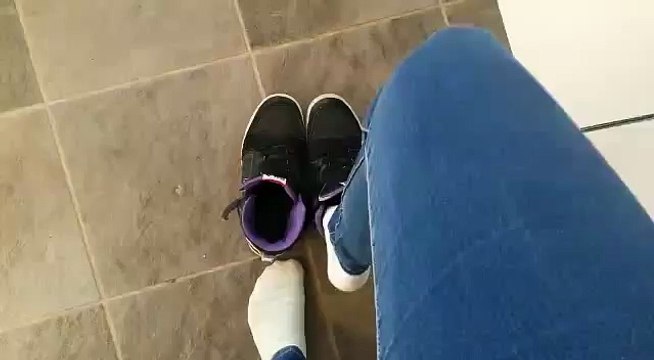 Girl taken ther shoes of and show dirt white socks