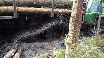 Forwarder John Deere 1110D in deep mud, extreme offroad