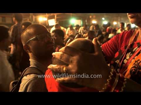 Volunteer distributes fish Prasadam at Nampally Exhibition Ground - India