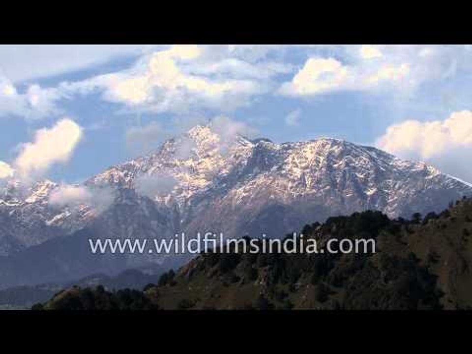 Solo pilot  paraglider glides through picturesque scapes