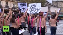 Topless Femen activists chased through Paris streets by riot police