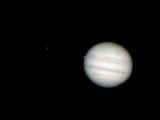 Jupiter through a telescope. Io disappears behind Jupiter