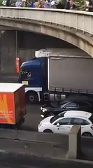 A taxi driver throws a stone from a bridge