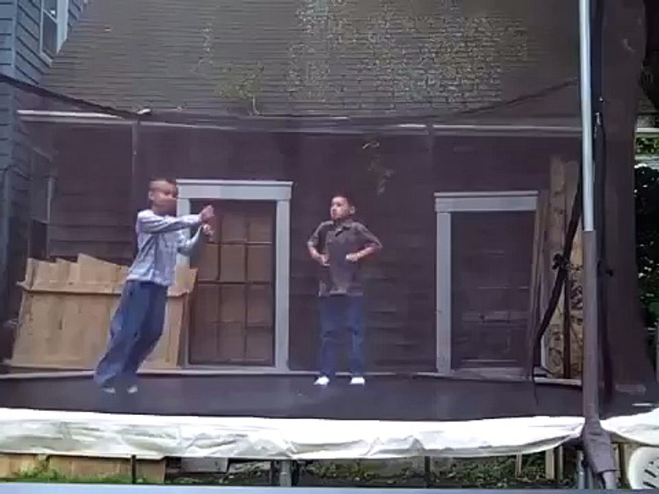 Kids doing back and front flips on a trampoline.