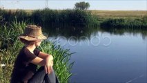 Beautiful woman relaxing rural lake metitative admire lifestyle health water. Stock Footage