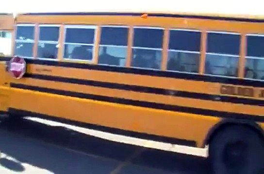A Blue Bird Golden Arrow School Bus Starting Up and Driving off From Meadow Brook Sobeys Edmonton