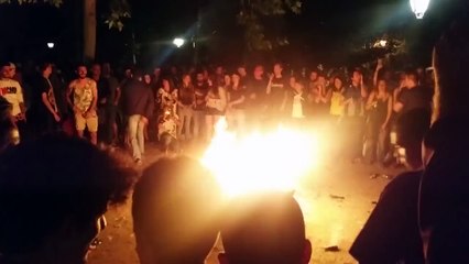 Two guys fall into a camp fire during a game