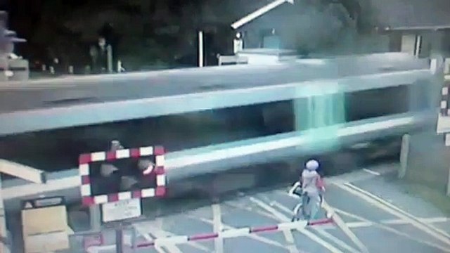 Shocking CCTV- Cyclist narrowly avoids being hit by train