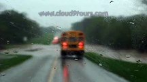 Bus drives through flooded road