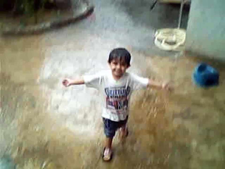 A CUTE KID ENJOYING RAIN