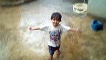 A CUTE KID ENJOYING RAIN