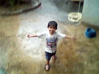 A CUTE KID ENJOYING RAIN