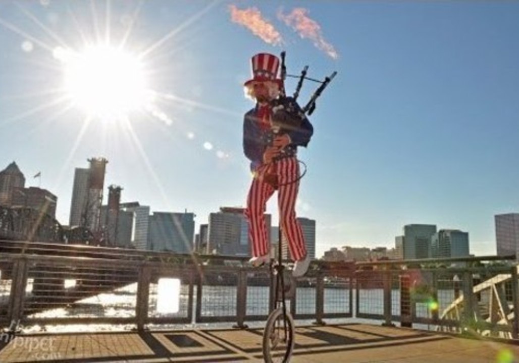 Unicyclist Plays the 1812 Overture on a Flaming Bagpipe