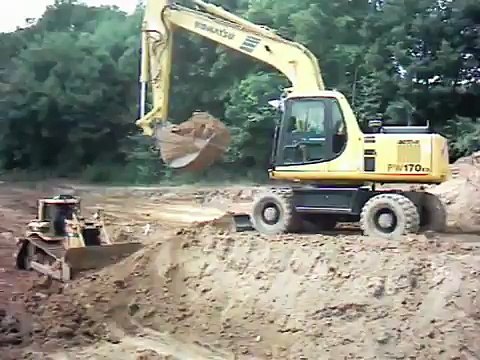 Komatsu excavator and Caterpillar dozer dozer and MAN dump truck at work