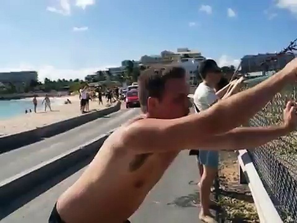 Surfing the Fence - St Maarten Maho Beach SXM near Sunset Beach Bar