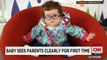 Baby sees parents clearly for first time