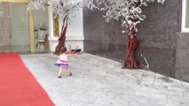 Little girl adorably chases paper in high wind gusts