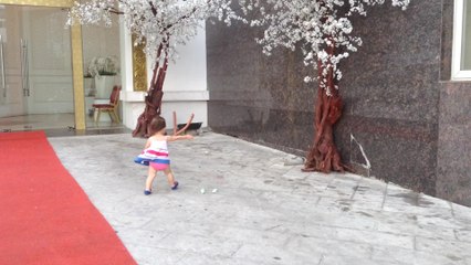 Little girl adorably chases paper in high wind gusts