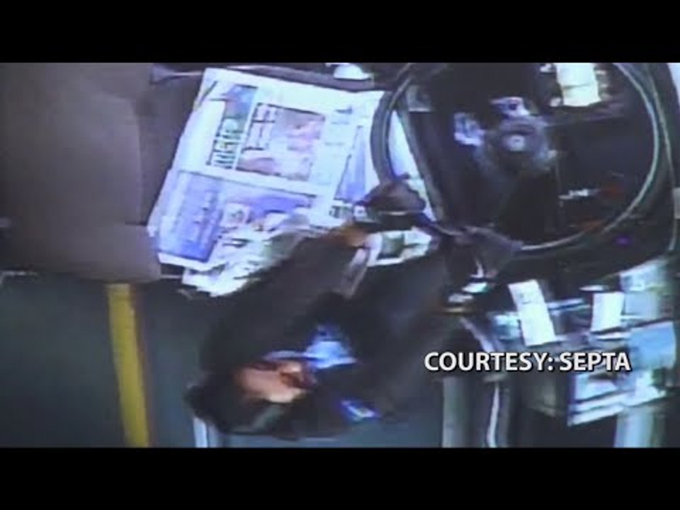 CCTV: Driver falls out of seat, bus nearly hits train